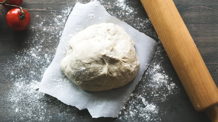 KEVJES silicone dough proofing containers with fresh pizza dough balls.
