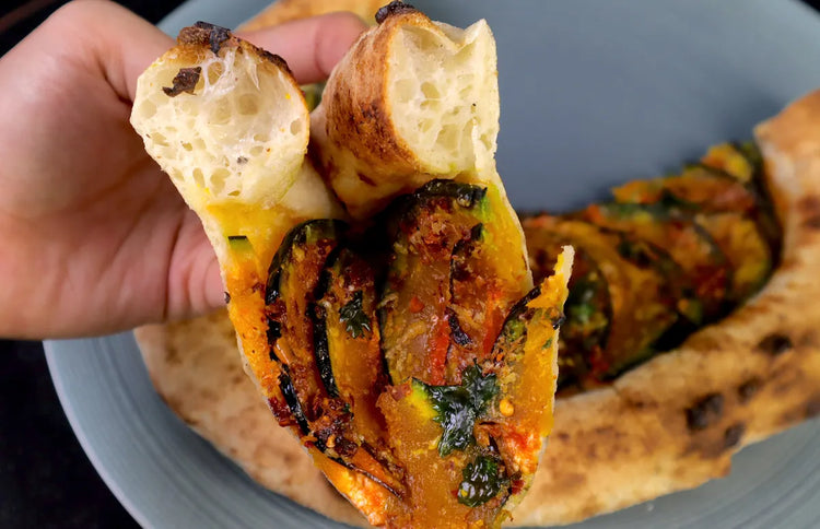 Freshly baked pizza with a well-risen browned crust after the dough warmed at room temperature