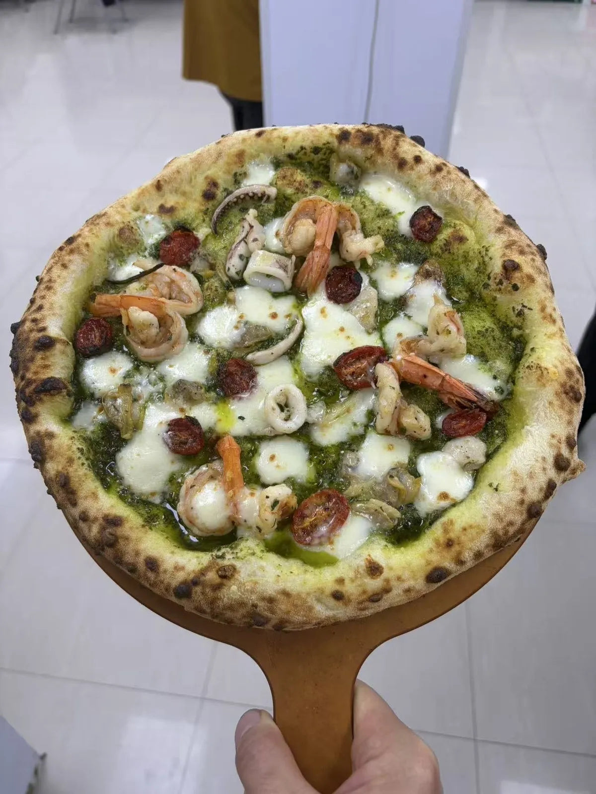 Freshly baked artisan pizza made from a 70% hydration pizza dough recipe showing a beautifully airy crust.